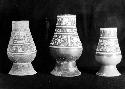 3 Polychrome Fine Orange tapered vases with pedestal bases.