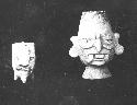 Two pottery vessels, human heads (front view).