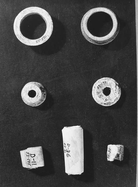 Bone artifacts. K.-6, K-4, K-1  55-531 (ear plugs) 53-171; 55-46 (spindle whorl)