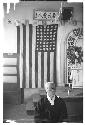 Man sitting down in front of American flag