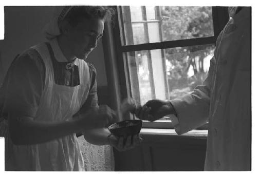 Doctor exchanging an object with a nurse