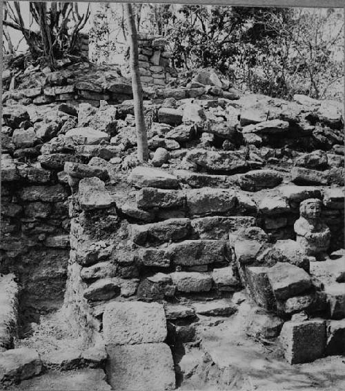 Stairway shrine and stone female idol at Structure Q214