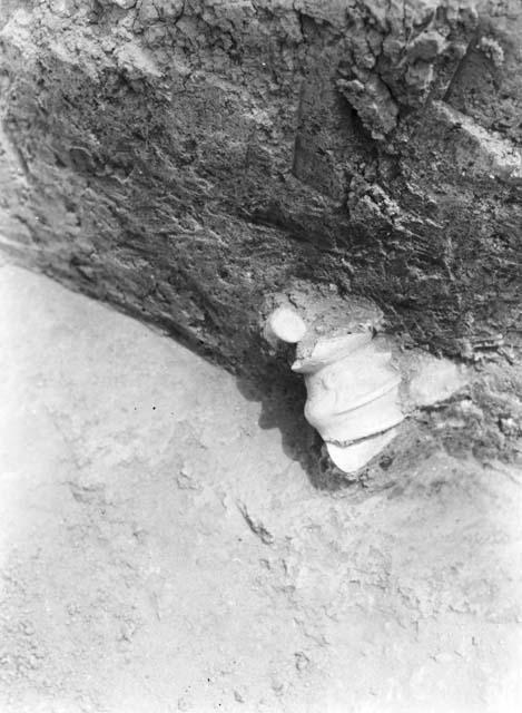 Excavation 3-31, grave 3A showing pottery head exposed in bank of trench