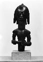 Wooden figurine frontal view, male god with child