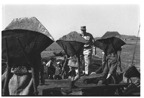 General Whitcomb walking among workers at cemetery