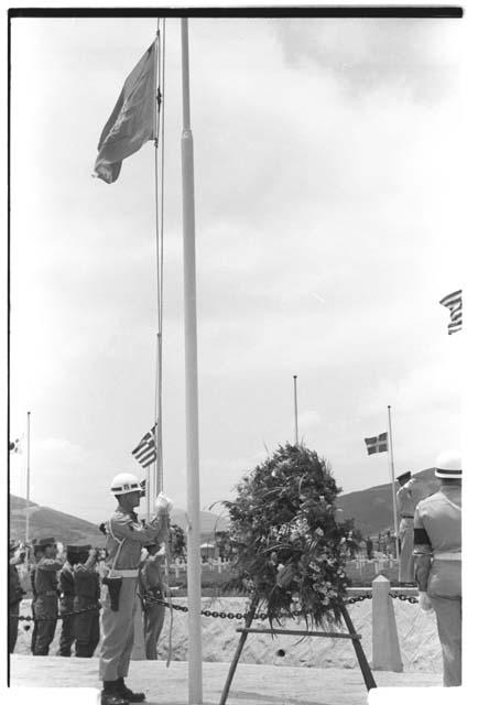 Soldiers standing around ceremonial wreath, vertical view