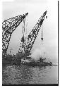 Two U.S. Army tugboats and large cranes