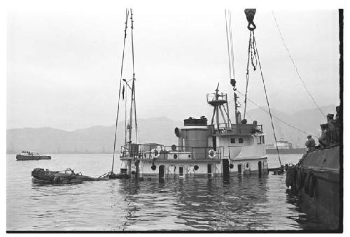 Side view of partially submerged U.S. Army tugboat