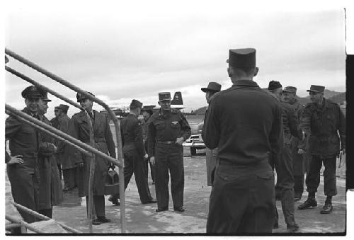 General Whitcomb, Colonel Slezak, and other American military personnel standing beside airplane