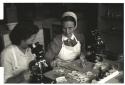 Nurses using microscopes