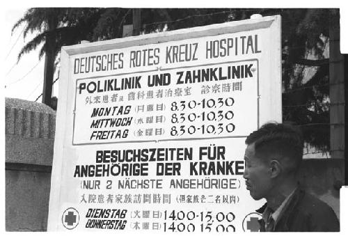 Man standing in front of sign