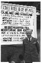 Man standing in front of sign