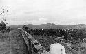 Man on wall in a hilly area