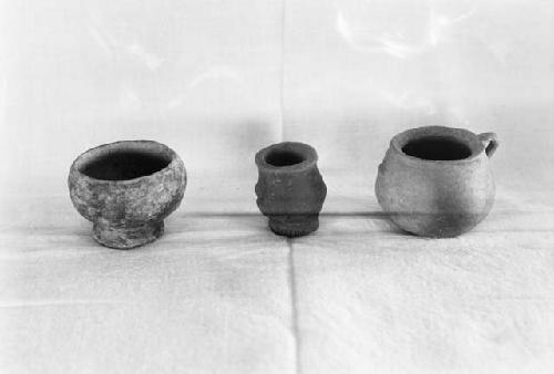 Pottery artifacts from excavation, miniature bowl, vase, and olla