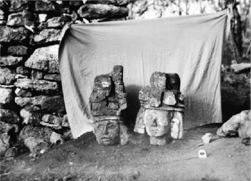 Two sculptured stone heads