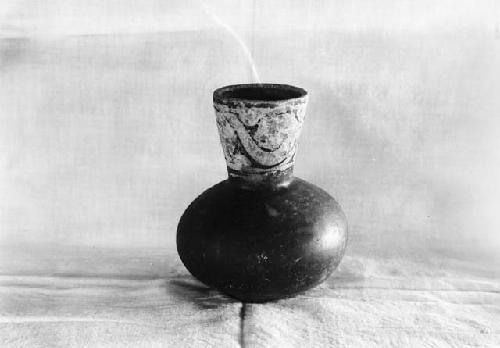 Extended neck jar with scroll design, excavation 1-31, grave A