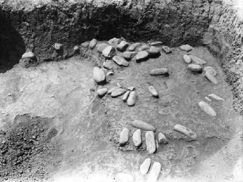 Grave excavation 3-31 showing exposed stones and floor