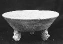 Tripod vessel with feet shaped as human heads - worn red slip.