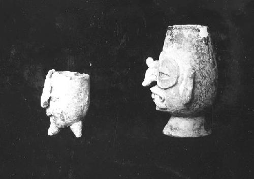 Two pottery vessels, human heads (side view).