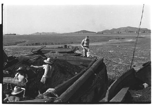 Workers digging at cemetery