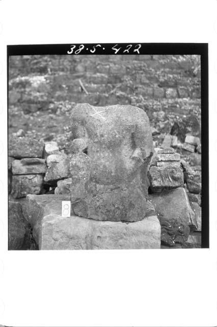 Torso arms and waist of stone figure in round