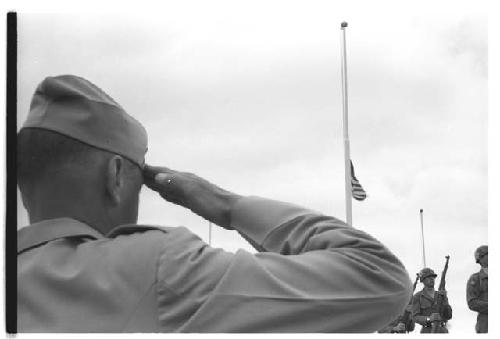 Soldier saluting as flag is raised