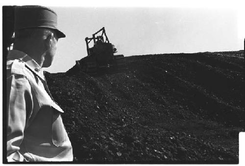 General Whitcomb looking at excavation machine in distance