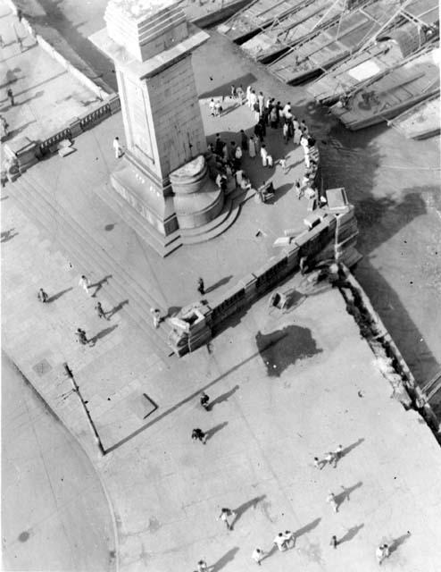 Looking down at people on sidewalk along river