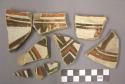 Ceramic, rim or body sherds, red and black designs on white, interior