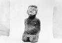 Kneeling, carved male figurine