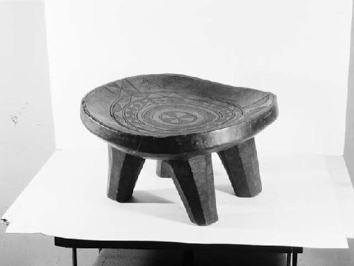Ceremonial wooden four legged stool with carved decoration