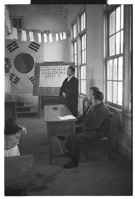 Man w/ board and flag in the background