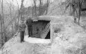 Men standing in front of bunker on a hill