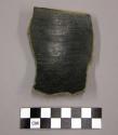 Bowl rim sherd with plain red slip exterior, black slip interior