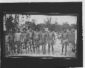 Group of men in front of huts