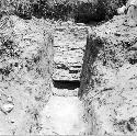 Trench with brick wall in background