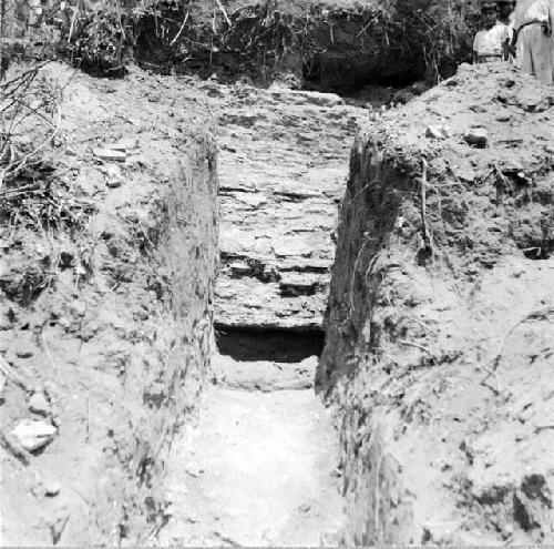 Trench with brick wall in background