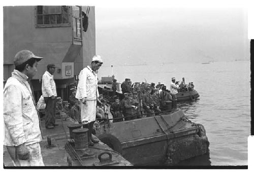 Men standing along edge of U.S. Army tugboat