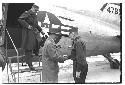 Colonel Slezak and General Whitcomb shaking hands outside airplane