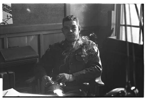 Colonel Hagerty holding a cigarette