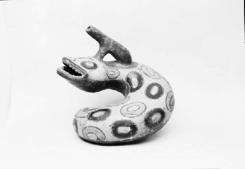 Polychrome pottery vessel in form of snake with spout, from grave 1, number 134