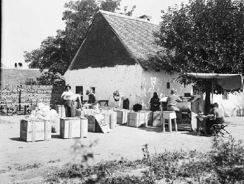 View of men packing up in the field house yard