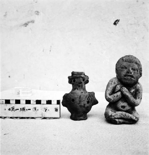 Two small, cream-colored ceramic figurines