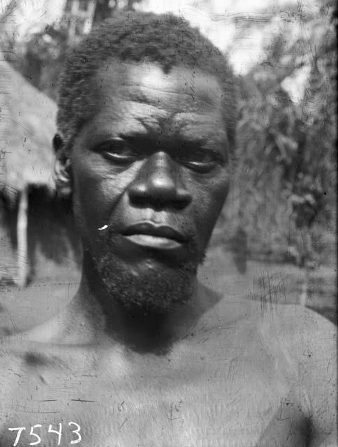 Frontal view of Karu male with chest scar tattooing