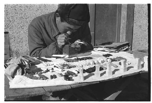 Street vendor crafting and selling dojang (personalized name stamps, used to sign documents)