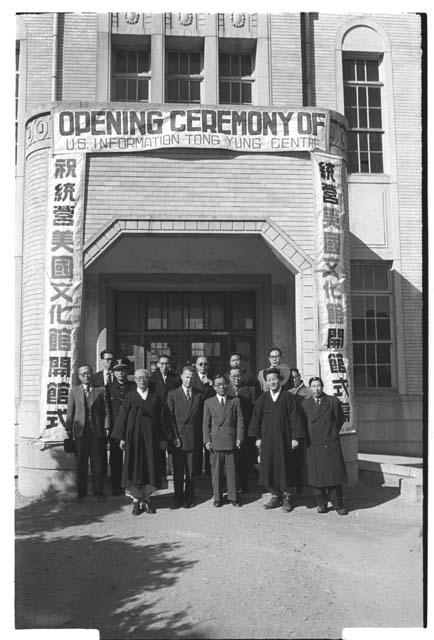Several men in front of Opening Ceremony of U.S. Information Centre Tong Yung