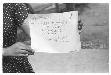 Woman holding sign Pictures by Roger Marshutz 117 So Fuller Ave Los Angeles·