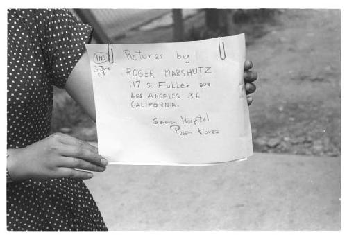 Woman holding sign Pictures by Roger Marshutz 117 So Fuller Ave Los Angeles·