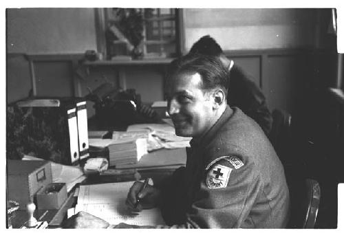 German Red Cross worker sitting at desk