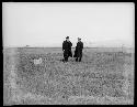 Two men posing in field